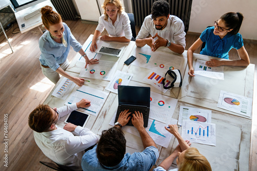 Group of multiethnic business people brainstorming, analyzing financial reports in office