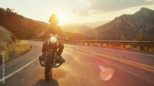 motorcyclist riding a bike free on a desert road landscape at sunset 