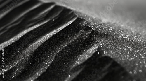 Close-up of a mountain of shiny black sand