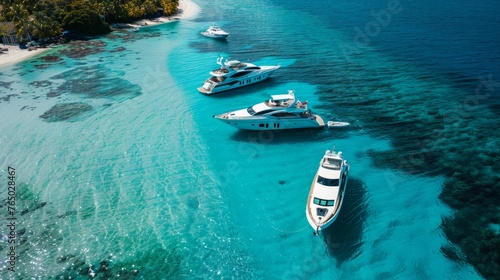 Three boats are floating in the ocean near a beach