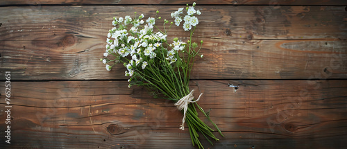 The image features a small bouquet of fresh, white flowers with green stems,