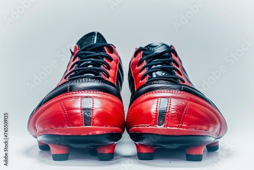 a pair of red and black football shoes