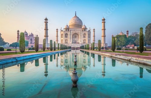 A photo of the iconic Taj Mahal at dawn, reflecting in its clear water pool with symmetrical composition and a blue sky background