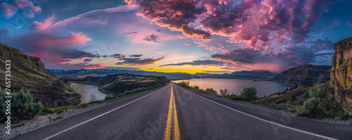 Journey to Dusk: Scenic Road Leading Towards a Sunset by the Mountains