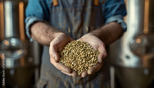 Close up of a brewer holding malt in his hands in a Brewery