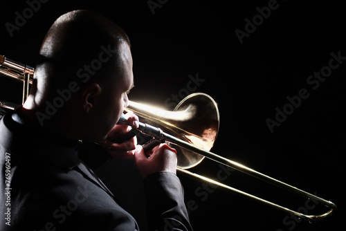 Trombone player. Trombonist playing brass instrument