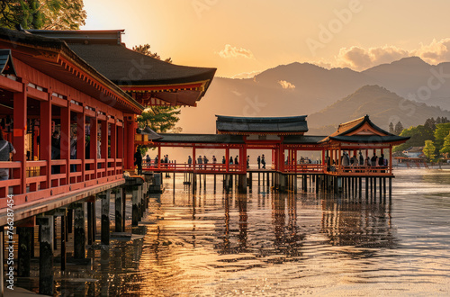 The red torii gate of Itsuk Japanese temple stands on the water surface at sunset