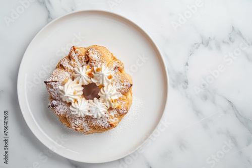 overhead view of paris brest pastry on white plate