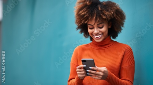 Smiling African woman using mobile phone