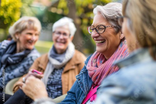 Talking, laughing and senior woman friends outdoor in a park together for bonding during retirement. Happy, smile and funny with a group of elderly people chatting in a garden for humor or fun