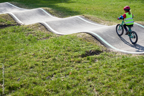 Petite fille faisant du vélo dans un Pump track