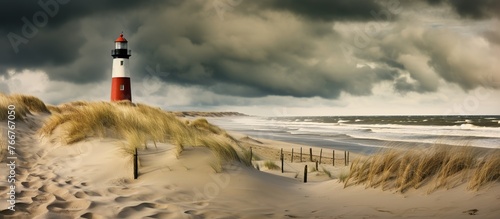 Famous brick lighthouse Darßer Ort Leuchturm with sand and dunes landscape and moody dark winter storm clouds