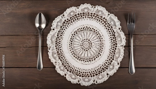 doily with spoon and fork on wooden background