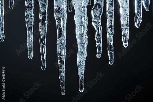 Icicles hanging isolated on black background