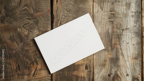 a mockup of a blank white postcard on a wooden table 