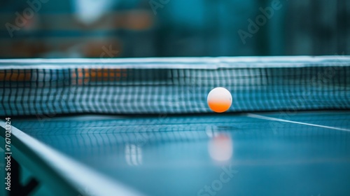 photo of a ping pong racket hitting a ping pong ball over a ping pong net