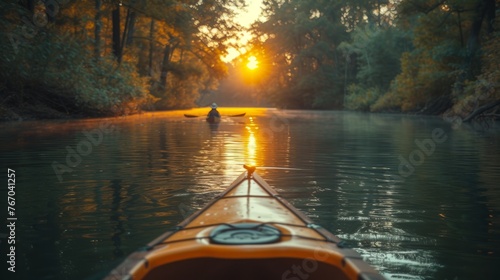 A person kayaking down a river under a sunny tree backdrop