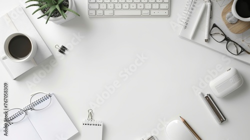 The top view of a white office desk table with a blank notebook, a computer keyboard, and other office supplies is expressed flat, with the copy space at the top.