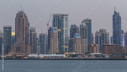 Dubai Marina skyline day to night timelapse as seen from Palm Jumeirah in Dubai, UAE.