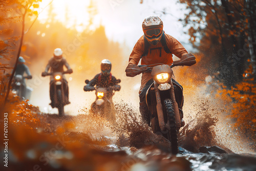 motorcycle racers on sports enduro motorcycles in off-road race riding on dirty road in nature at sunset