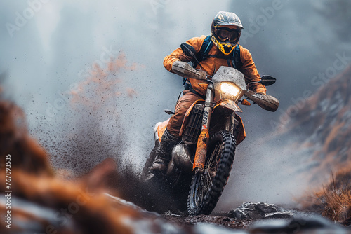 man motorcycle biker racer on sports enduro motorcycle in off-road race rally riding on dirty road in nature