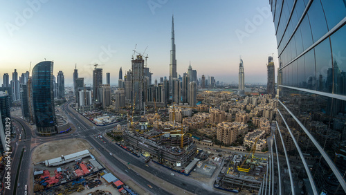 Dubai Downtown day to night timelapse. Aerial view over big futuristic city by night.