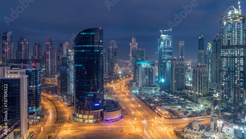 Dubai Downtown night to day timelapse. Aerial view over big futuristic city by night.