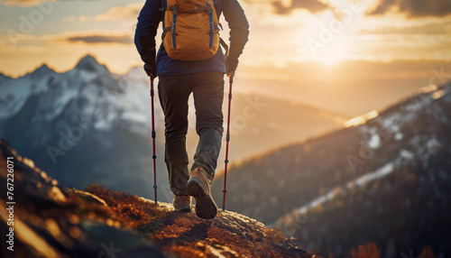 Hiker climbing mountains and reaching the top. Male hiking and overcoming obstacles as ascends the rocky peaks. Leader success and achievement concept