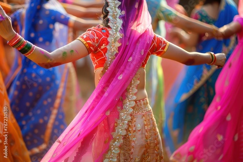 photograph of Festival of Colors: Indian Women Dressed in a multi-colored sari. Have fun dancing Amidst the colorful festival atmosphere It represents beautiful culture and traditions. 