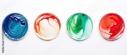 Four oval soap dishes with various colored soap on white