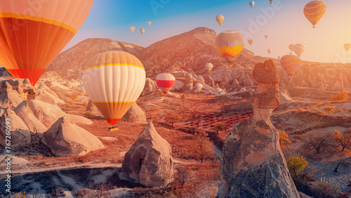 Landscape sunset in Cappadocia with set colorful hot air balloon fly in sky with sunlight. Concept tourist travel Goreme Turkey.