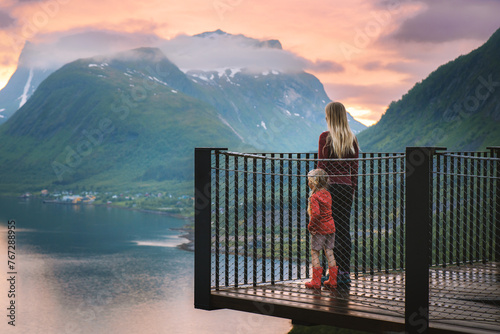 Family vacations in Norway mother and daughter on Bergsbotn viewpoint sightseeing sunset landscape mountains and sea, travel lifestyle outdoor, parent and child exploring Senja island