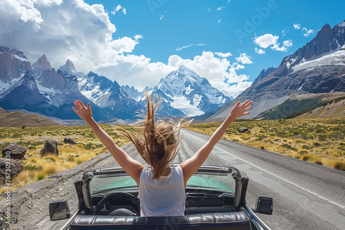 Woman with arms raised out of car sunroof enjoying mountain scenery. Road trip adventure and freedom concept. Design for banner, poster, and travel inspiration.