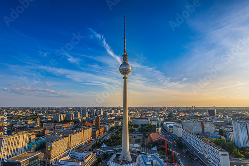 Berlin skyline in summer. Television tower in the center of the capital of Germany in the evening. High-rise buildings around the attraction at Alexanderplatz at sunset