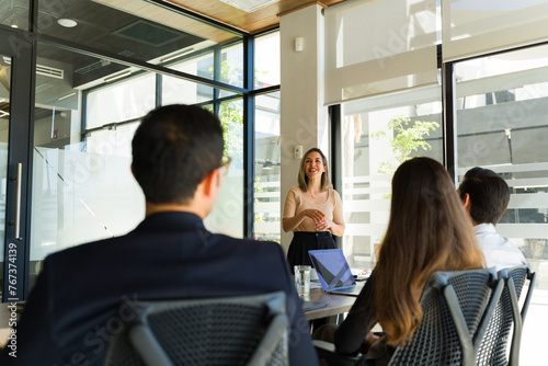 Cheerful businesswoman giving a presentation in a meeting room