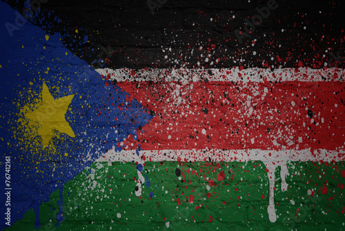 colorful painted big national flag of south sudan on a massive brick wall