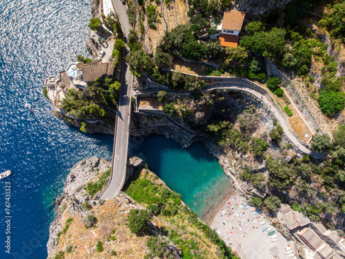 created by dji camera summer in Fiordo di Furore in Italy. coast with a secret beach near Positano. bridge across the bay. the blue color of the Adriatic Sea.