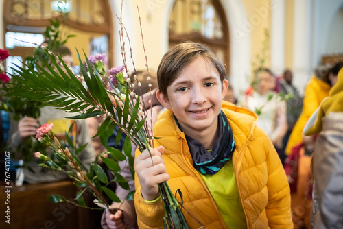 An 11-year-old boy in church on Palm Sunday.