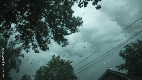 Gray clouds loom overhead as torrential rain falls in a relentless downpour causing flooding and chaos on the ground below.