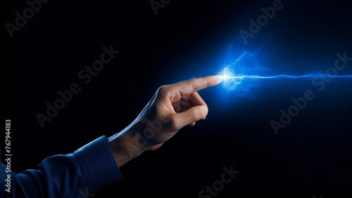 A human finger touching a spark of electrical energy illustrating a concept of power and connection. Futuristic technology of information transfer