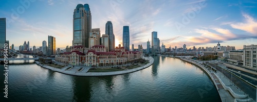 Aerial shot of an urban skyline with landmarks along the Haihe River in Tianjin, China at sunset