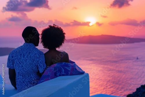 Couple enjoying sunset over the ocean in Santorini, Greece. Breathtaking view of caldera. Honeymoon getaway for African American couple.