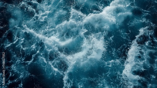 Aerial view showcasing the powerful and turbulent waves of a deep blue ocean.