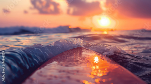 Surfboard and rising sun, coast beach at sunset.