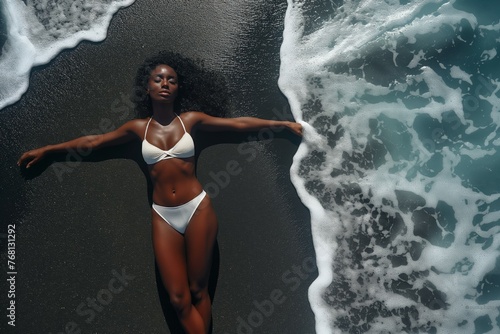 Woman embracing sun on sandy beach