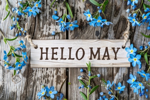 "HELLO MAY", text, wooden background with blue flowers, white wood banner Generative AI