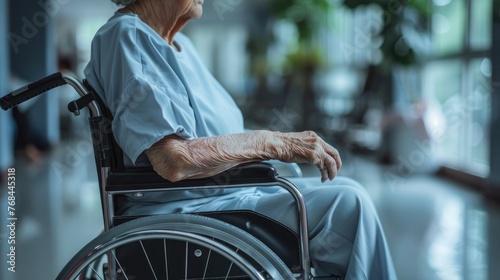 Close up of older woman sitting in wheelchair taken care of in hospital, older people disability rehab healthcare concept