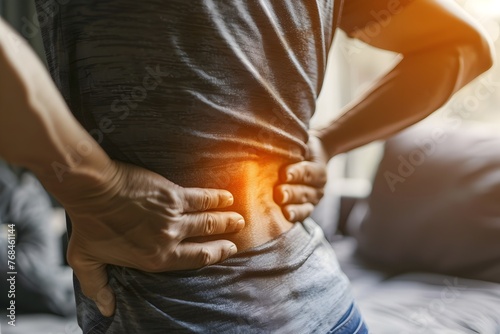 Man Experiencing Back Pain at Home, Seeking Relief