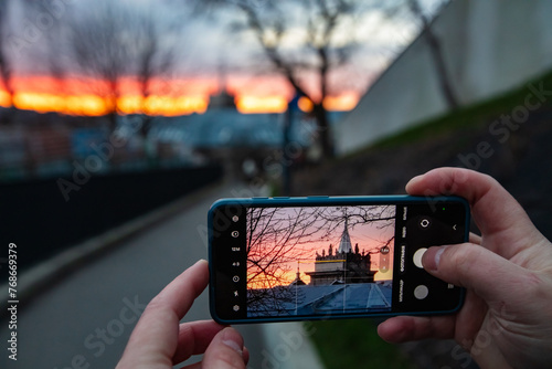 male hands holding smartphone and making photos in Lviv