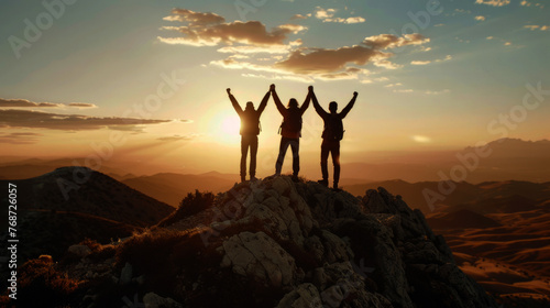Together overcoming obstacles with three people holding hands up in the air on mountain top , 